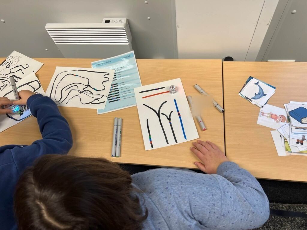 Die Schüler:innen unternehmen erste Versuche mit dem Ozobot.