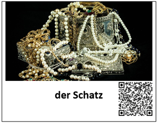 Ein Bild einer Kiste mit sehr viel Schmuck ist mit den Worten "der Schatz" beschriftet. Daneben befindet sich ein QR-Code, welcher zur auditiven Darstellung des Begriffes führt.